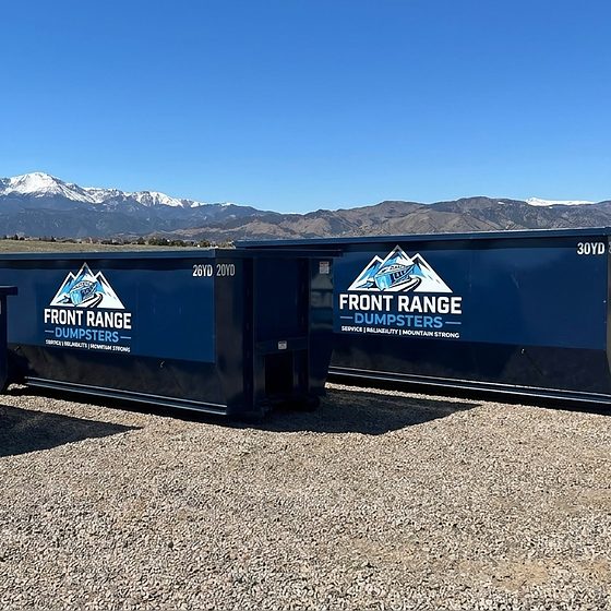 Three Front Range Dumpsters roll-off containers, 10, 20 and 30 yards, on gravel with mountains behind